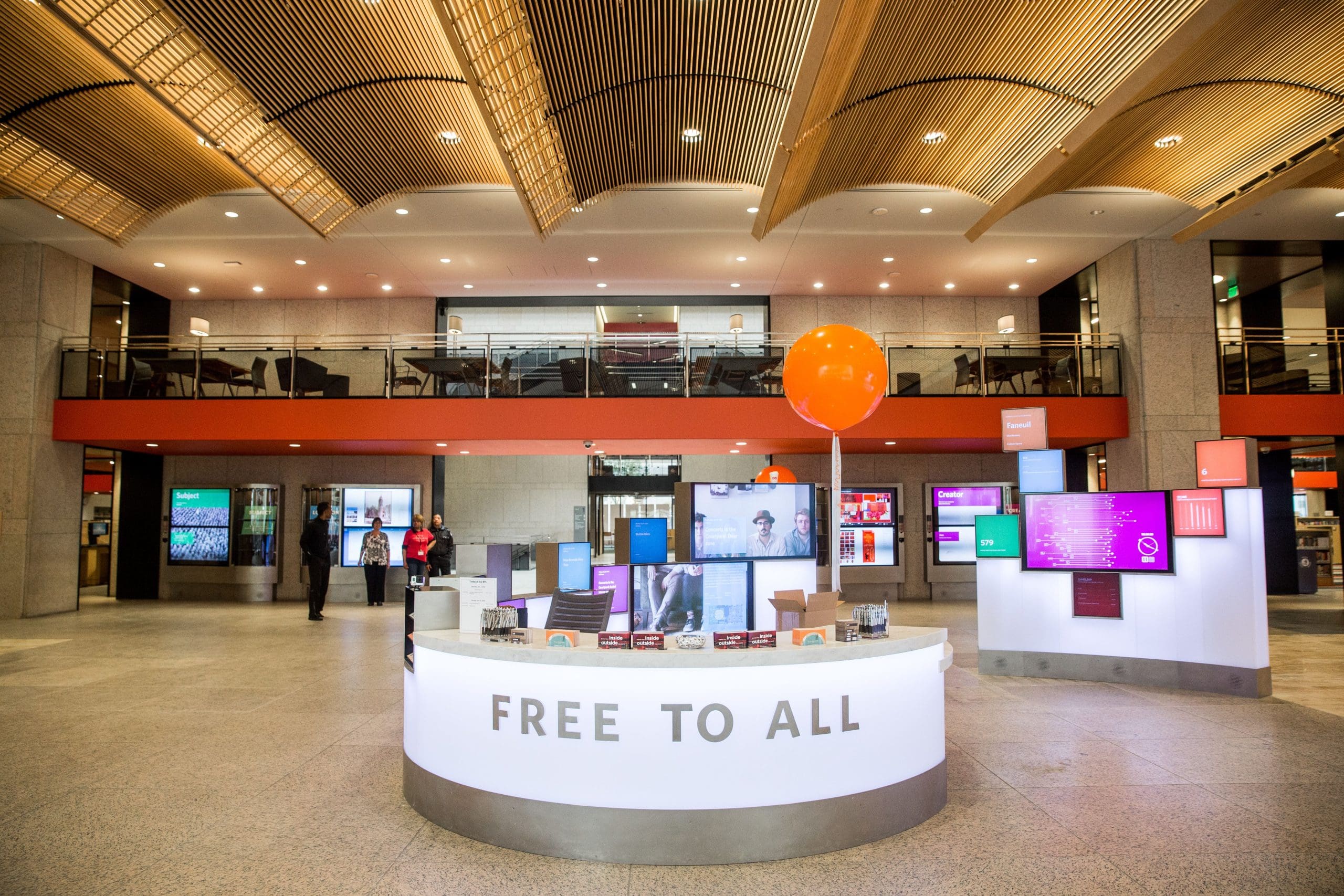 Welcome Services desk in the Boylston Street Building at the Central Library with the words "Free to All" in all-caps