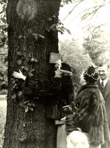 Helen Keller hugging a tree.